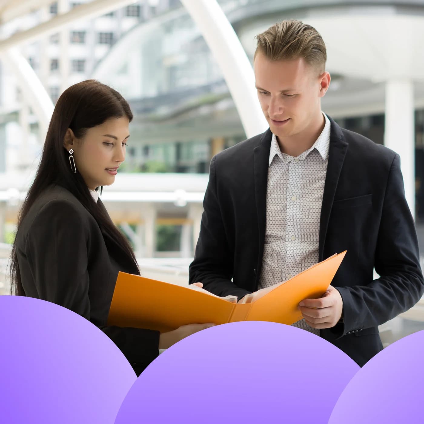Business colleagues reviewing documents outdoors